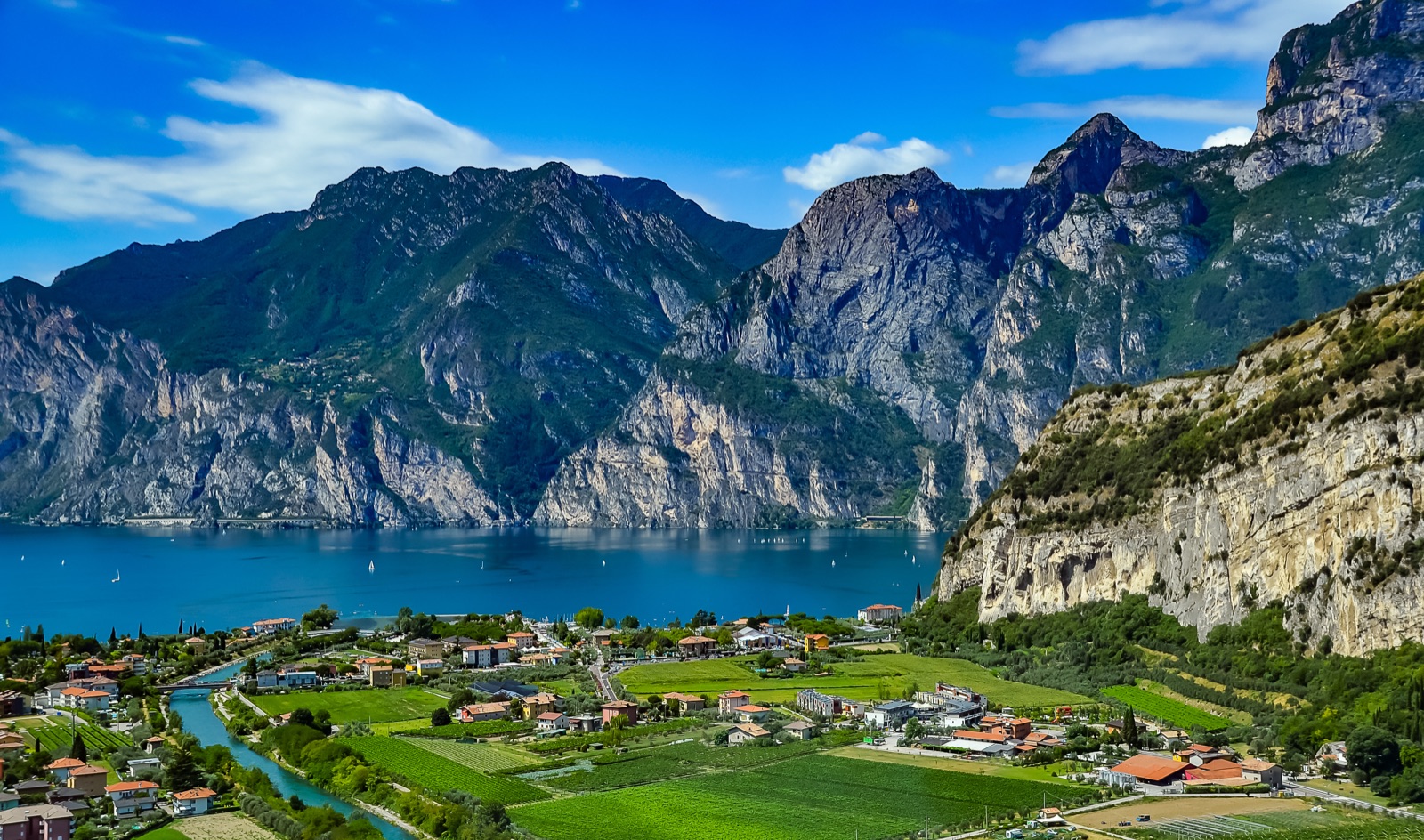 Panoramic view of Lake Garda with village and Alpine mountains